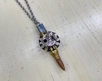 Steampunk pendant necklace made with bullet and bejeweled vintage watch movement
