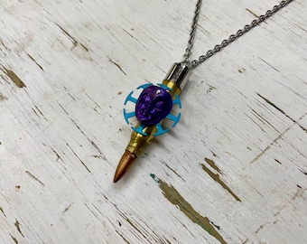 Steampunk necklace made with bullet and bejeweled sleeping robot
