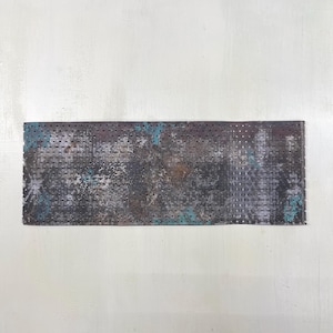 Peut inclure: Tôle métallique rectangulaire perforée de nombreux petits trous, avec une finition vieillie dans des tons de gris, de brun et de turquoise. La surface présente un aspect texturé, suggérant une esthétique industrielle ou vintage.