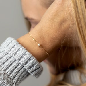 a close up of a person wearing a bracelet