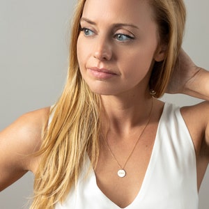 a woman in a white top posing for a picture