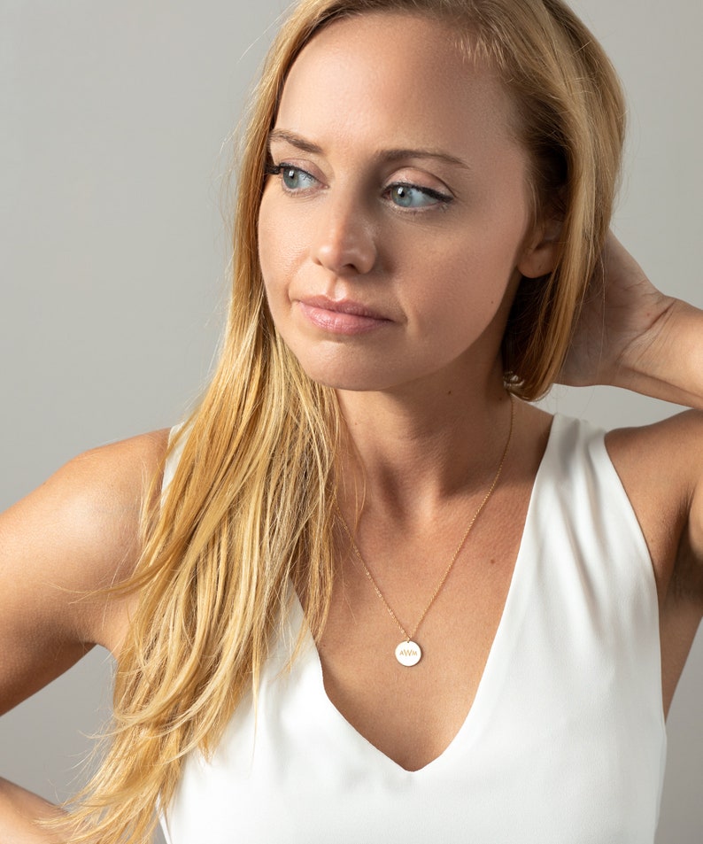 a woman in a white top posing for a picture