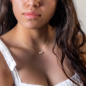 a close up of a woman wearing a necklace