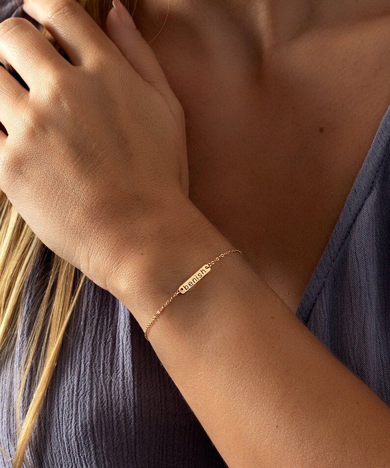 a close up of a person wearing a gold bracelet