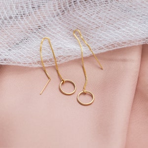 a close up of a pair of gold earrings