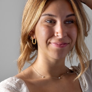 a close up of a person wearing a necklace