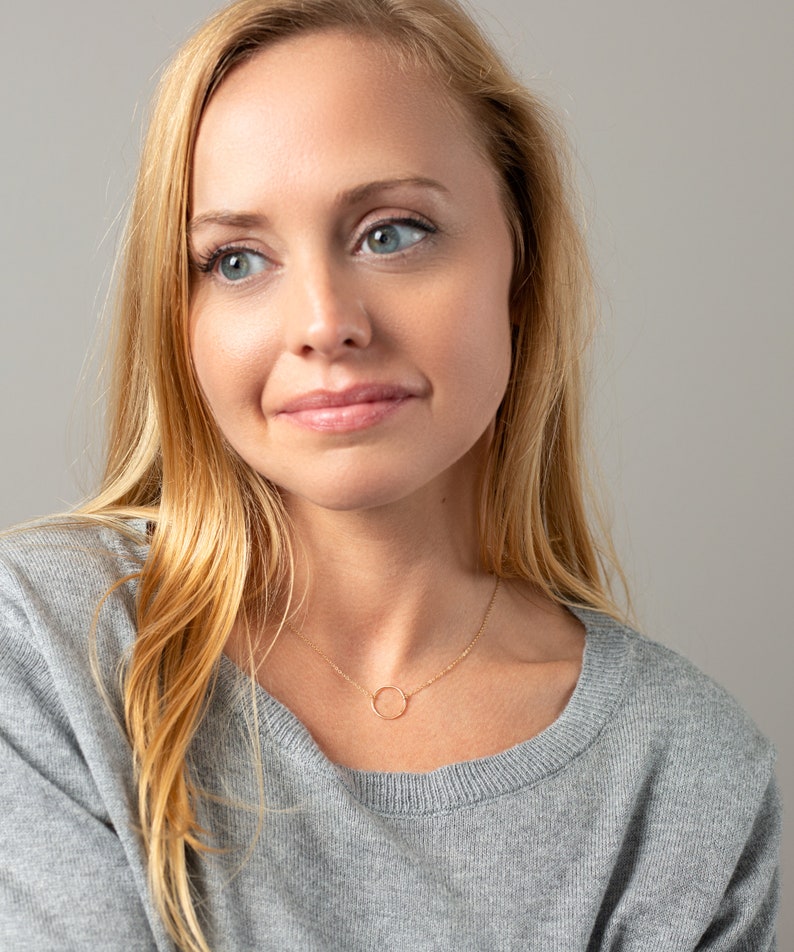 a beautiful blonde woman with blue eyes posing for a picture