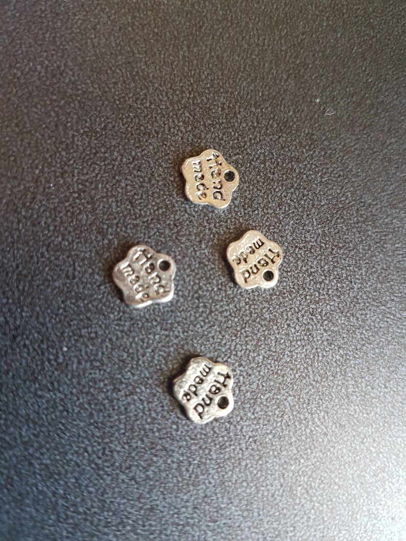 10 Small flower charms quot;hand madequot; in silver metal 10 Small flower charms quot;hand madequot; in silver metal