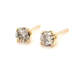 May include: A pair of stud earrings featuring round, faceted, clear stones set in four-prong yellow gold settings. Each earring includes a thin, straight post extending from the back of the setting, designed for secure placement in a pierced earlobe.