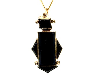 May include: A gold pendant necklace with a black onyx stone in a geometric shape.