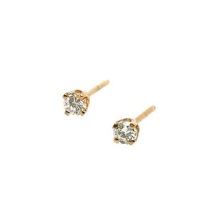 May include: A pair of stud earrings featuring round, clear, faceted stones set in gold-toned metal prongs. Each earring includes a thin, straight post extending from the back of the setting, designed for secure placement in a pierced earlobe.