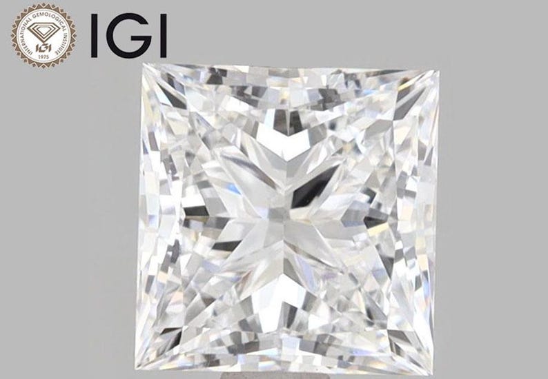 May include: A clear, square-shaped diamond with a brilliant cut. The diamond is certified by the International Gemological Institute (IGI).
