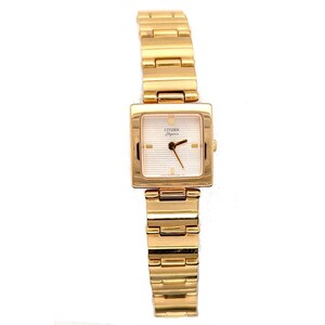 May include: A gold-tone Citizen Elegance wristwatch featuring a square case and a matching link bracelet. The watch face is white with horizontal textured lines, gold-tone hour markers, and thin black hands. The brand name Citizen is printed in black.