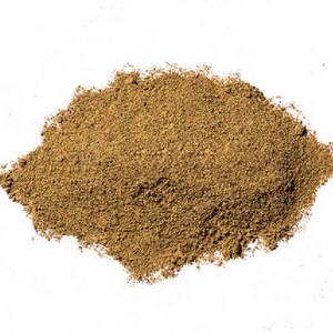 May include: A mound of finely ground, light brown powder on a white backdrop. The powder has a slightly coarse texture, suggesting it is a spice or herb. The image is well-lit, showing the details of the powder.