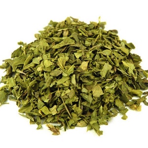 May include: A pile of dried green parsley leaves, a common herb used in cooking.