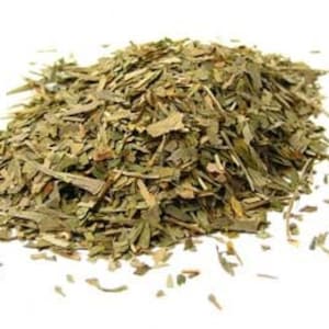 May include: A pile of dried green herbs, likely tarragon, for culinary use.