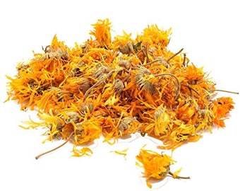 May include: Dried calendula petals, a vibrant orange-yellow color, are scattered on a white background. The petals are loose and appear to be ready for use in herbal remedies or crafts.
