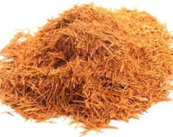 May include: A pile of finely shredded, reddish-brown bark. The texture appears fibrous and dry, with individual strands visible. The bark is likely from a tree and is used for various purposes.