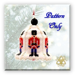 May include: A beaded Christmas bell ornament with a soldier design in red, black, blue, and gold. The ornament has a black bead at the top and a red ribbon for hanging. The image includes the text "Pattern Only".