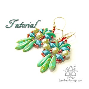 May include: Teal and white beaded earrings with red accents. The earrings are shaped like a flower with a teardrop-shaped pendant. The earrings are hanging from gold hooks.