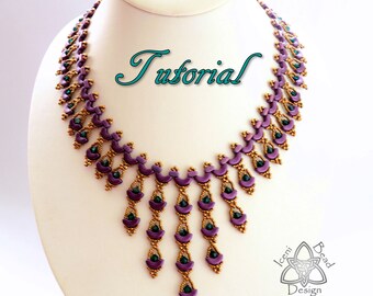 May include: A purple and gold beaded necklace with a cascading design. The necklace is on a white mannequin bust. The word "Tutorial" is written in cursive above the necklace.