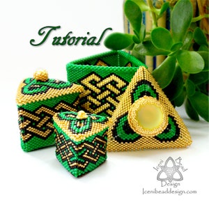 May include: A set of three beaded boxes in green, black, and gold. The boxes are in the shape of a square, a triangle, and a rectangle. The boxes are decorated with a geometric pattern. The boxes are on a white surface.