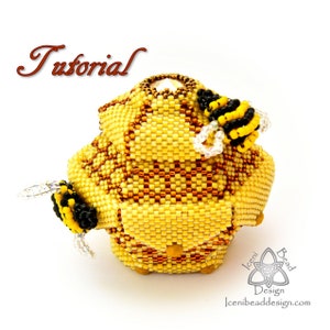 May include: A beaded beehive with three bees, made with yellow, black, and brown beads. The beehive is a geometric shape with a textured surface. The bees are positioned on the sides of the beehive. The beehive is a beaded craft project.