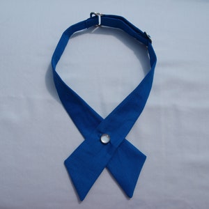May include: A royal blue necktie with a white button closure. The tie is made of a soft, smooth fabric and has a classic, elegant design.