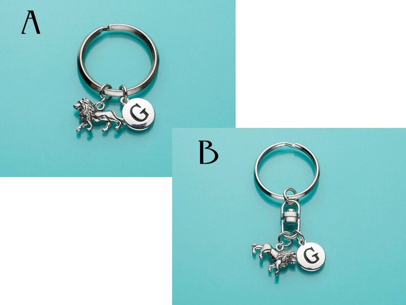 May include: Two silver keychains with a lion and a unicorn charm. Both keychains have a silver letter G charm.