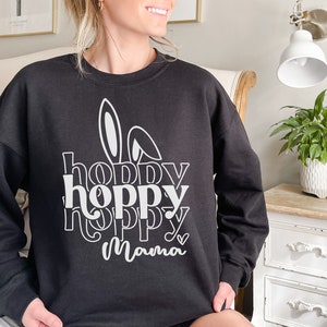 May include: Black sweatshirt with a white graphic design that says "hoppy hoppy hoppy mama" with a bunny ear design.