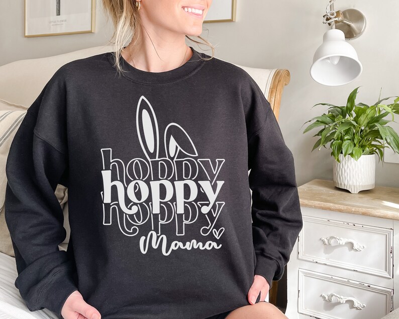 May include: Black sweatshirt with a white graphic design that says "hoppy hoppy hoppy mama" with a bunny ear design.