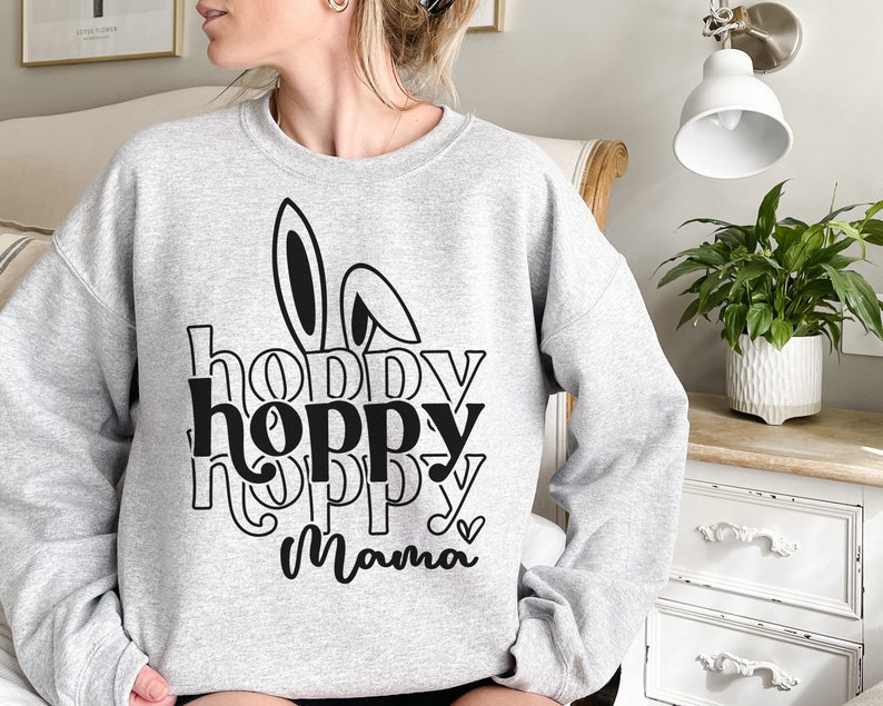 May include: Gray sweatshirt with a black bunny ear graphic and the text "hoppy hoppy hoppy Mama" printed on the front.