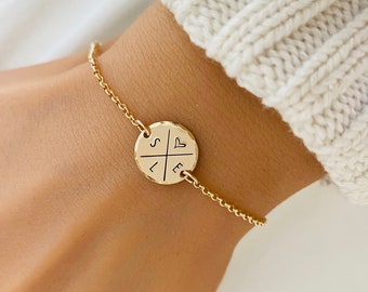 May include: Gold chain bracelet with a round charm featuring the letters "S", "L", "E", and a heart symbol.