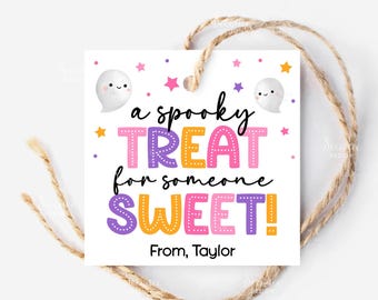 May include: A white square gift tag with a Halloween theme. The tag features the text "a spooky TREAT for someone SWEET!" in colorful letters, along with two cartoon ghosts and star accents. A twine string is attached.