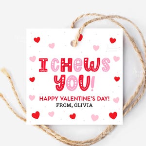 May include: A white Valentine's Day gift tag with red and pink hearts. The tag reads "I CHEWS YOU!" in red and pink lettering, with "HAPPY VALENTINE'S DAY! FROM, OLIVIA" below. A twine string is attached.
