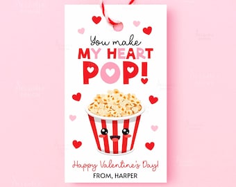 May include: A Valentine's Day gift tag with a red and white striped popcorn bucket illustration. The tag reads "You make my heart POP!" with hearts and the message "Happy Valentine's Day! From, Harper."