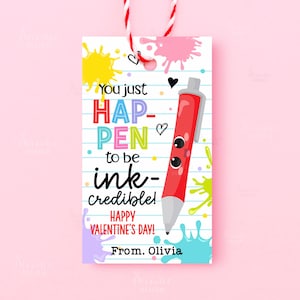 May include: A Valentine's Day gift tag with a red and white string. The tag features a red pen with a face, colorful ink splatters, and the text "You just HAPPEN to be ink-credible! Happy Valentine's Day!"