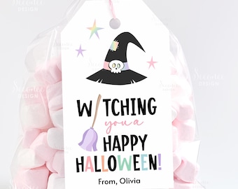 May include: A clear cellophane bag filled with pink and white marshmallows, tied with a pink ribbon. A white tag features a witch hat, stars, and the text "Watching you a Happy Halloween!" with the name "Olivia".