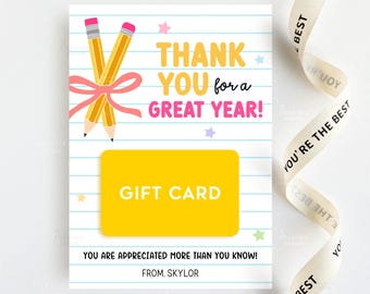 May include: A gift card with a school theme. The card has a yellow gift card area, the text "THANK YOU for a GREAT YEAR!", and two pencils tied with a pink bow. The card also has the text "YOU ARE APPRECIATED MORE THAN YOU KNOW!" and "FROM. SKYLOR". A ribbon with the text "YOU'RE THE BEST" is in the background.