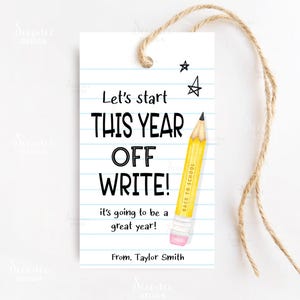 May include: A white gift tag with a yellow pencil illustration and the text "Let's start this year off write! It's going to be a great year! From. Taylor Smith".