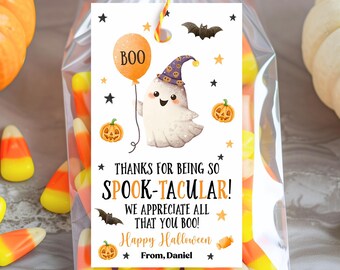 May include: A clear cellophane bag filled with candy corn, tied with a yellow and orange string. A Halloween-themed tag features a cartoon ghost holding a balloon that says "BOO". The tag reads "Thanks for being so Spook-tacular! Happy Halloween!"