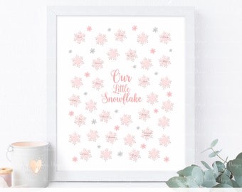 Op de afbeelding: Een printbaar roze en zilveren sneeuwvlokkenbord met de tekst "Our Little Snowflake".