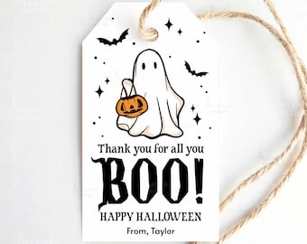 May include: A white Halloween gift tag with a cartoon ghost holding a jack-o'-lantern. The tag includes the text "Thank you for all you BOO!" and "HAPPY HALLOWEEN". A twine string is attached to the tag.