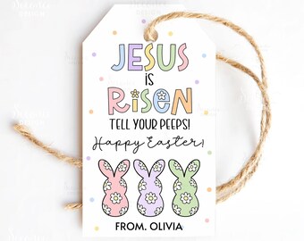 May include: White Easter gift tag with the text "JESUS is RISEN TELL YOUR PEEPS! Happy Easter!" and three bunny illustrations. The tag has a jute twine string for hanging and the name "OLIVIA" at the bottom.
