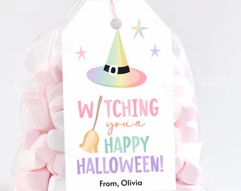 May include: A clear cellophane bag filled with pink and white marshmallows, tied with a pink ribbon and a decorative tag. The tag features a colorful witch hat, stars, and the text "Witching you a Happy Halloween!" with the name "Olivia".