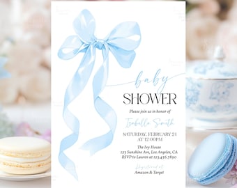 May include: A blue baby shower invitation with a large blue bow and the text "baby shower" in black. The invitation includes the name "Isabella Smith", the date "Saturday, February 21", the time "at 12:00PM", the location "The Ivy House, 123 Sunshine Ave, Los Angeles, CA", the RSVP information "RSVP to Lauren at 123.456.7890", and the registry information "Amazon & Target".