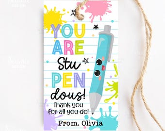 May include: A white gift tag with a lined paper design and a twine string. The tag features colorful text that reads "YOU ARE Stu PEN dous!" with a cartoon pen illustration and paint splatters. The text "Thank you for all you do! From. Olivia" is also included.