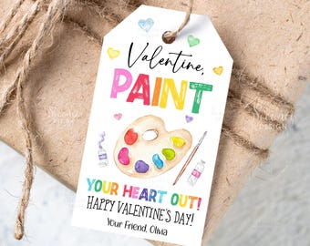 Puede incluir: Una etiqueta de regalo blanca de San Valentín con las palabras "Valentine, PAINT" en letras coloridas. La etiqueta presenta una paleta de pintura de acuarela, tubos de pintura y un pincel. También se incluye el texto "YOUR HEART OUT! HAPPY VALENTINE'S DAY!"