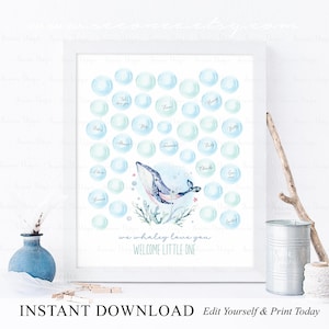Peut inclure: Une impression encadrée avec une illustration à l'aquarelle d'une baleine entourée de bulles bleues. La baleine est bleue avec des détails roses, et les bulles contiennent des noms. Le texte dit "we whaley love you" et "WELCOME LITTLE ONE".