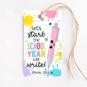 May include: A school-themed gift tag with a pink pen illustration and the text "Let's start the SCHOOL YEAR off write!" in colorful letters. The tag has a lined paper background with paint splatters and a twine string.